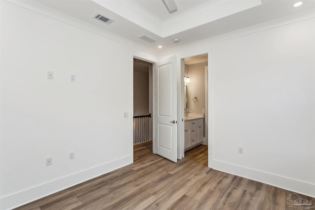 unfurnished bedroom featuring baseboards, visible vents, wood finished floors, and recessed lighting