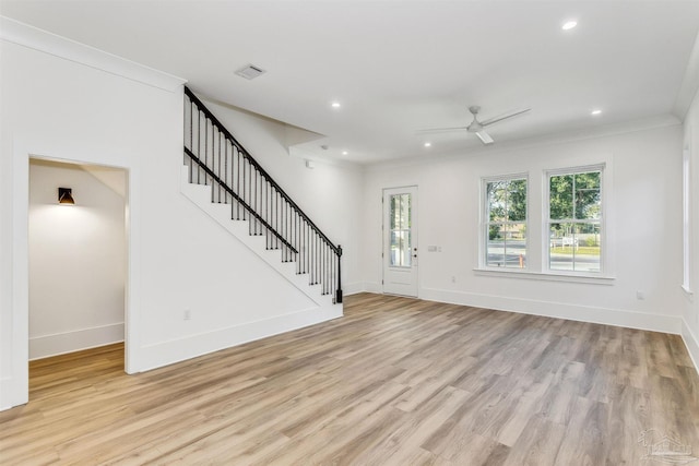 interior space featuring a healthy amount of sunlight, light wood-style flooring, stairway, and recessed lighting