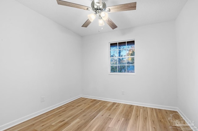 spare room featuring light wood-type flooring and ceiling fan