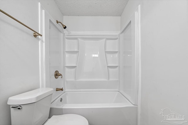 bathroom with shower / washtub combination, toilet, and a textured ceiling