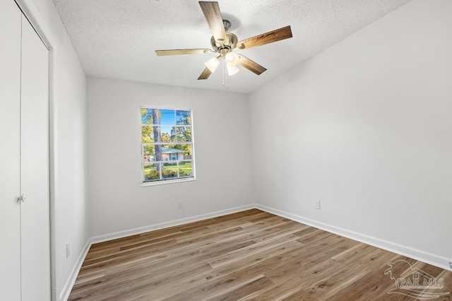 unfurnished room featuring hardwood / wood-style floors, a textured ceiling, and ceiling fan