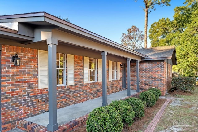 view of side of property with covered porch