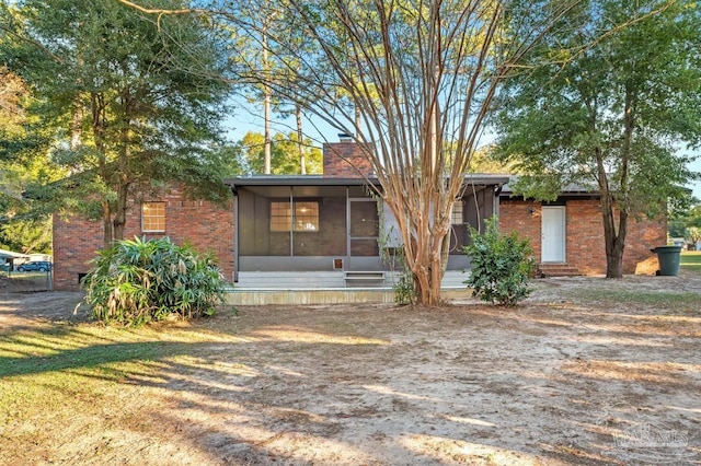 view of front of property featuring a sunroom