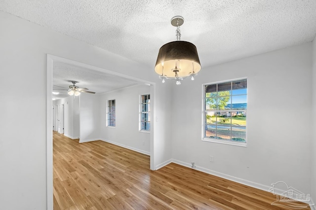 unfurnished room featuring hardwood / wood-style flooring, a textured ceiling, and ceiling fan