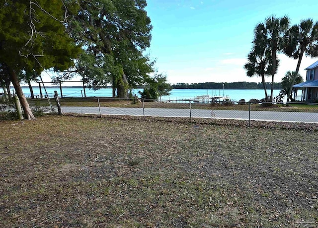 view of yard featuring tennis court and a water view