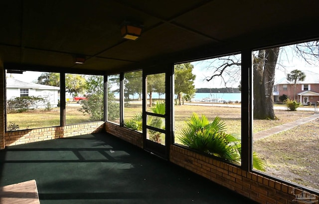 sunroom / solarium with a water view