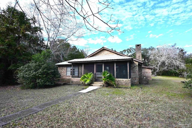 view of front of house featuring a front yard and a sunroom