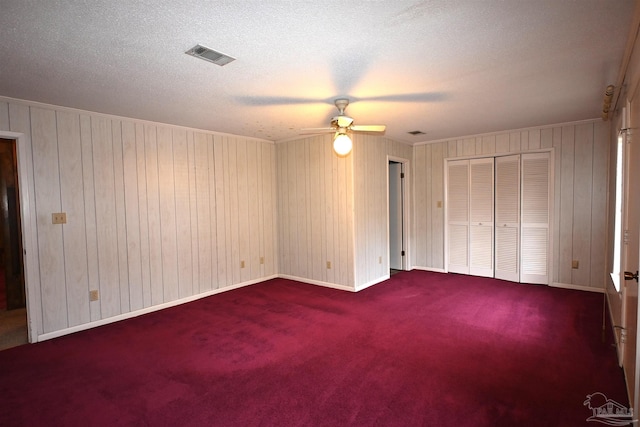 unfurnished bedroom with ceiling fan and carpet