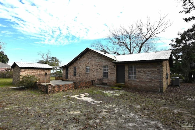 rear view of property with central air condition unit and a patio area