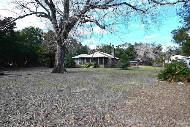 view of yard featuring a sunroom