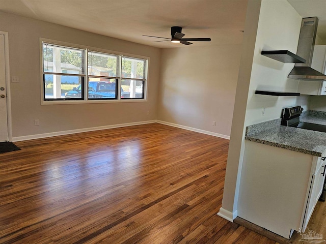 interior space with hardwood / wood-style floors and ceiling fan