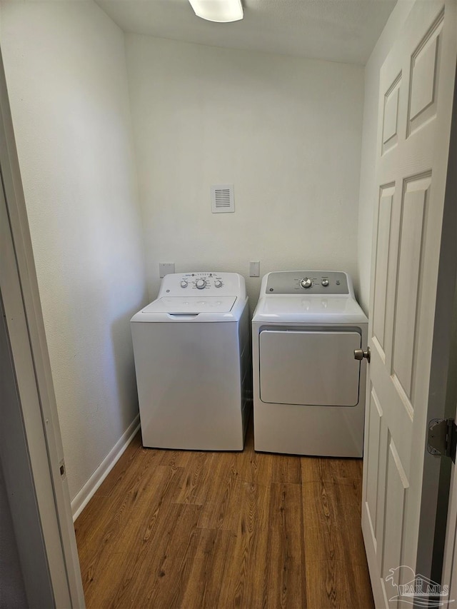 washroom with dark hardwood / wood-style floors and independent washer and dryer