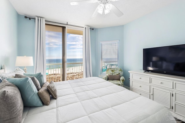 bedroom featuring a textured ceiling, access to outside, and ceiling fan