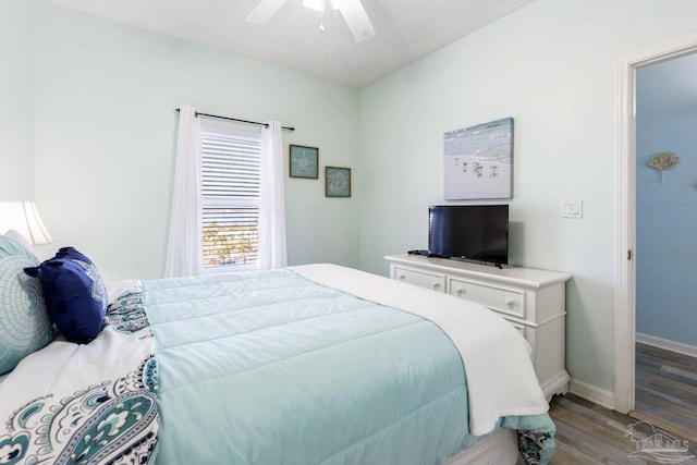 bedroom featuring ceiling fan, a textured ceiling, and light wood-type flooring