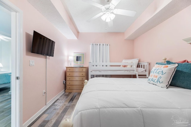 bedroom with hardwood / wood-style floors and ceiling fan