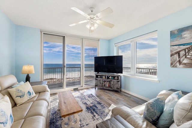 living room with light hardwood / wood-style floors and ceiling fan