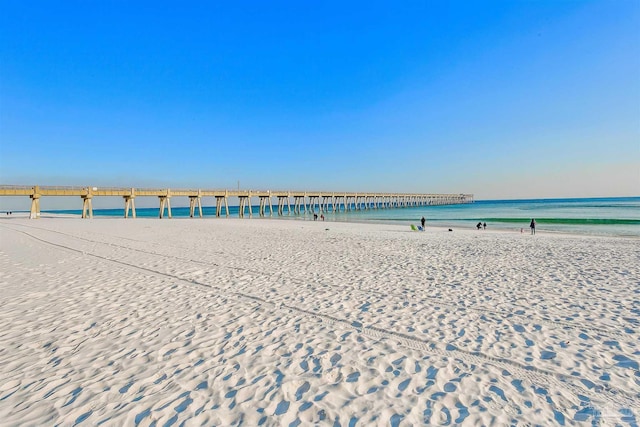 view of community featuring a beach view and a water view