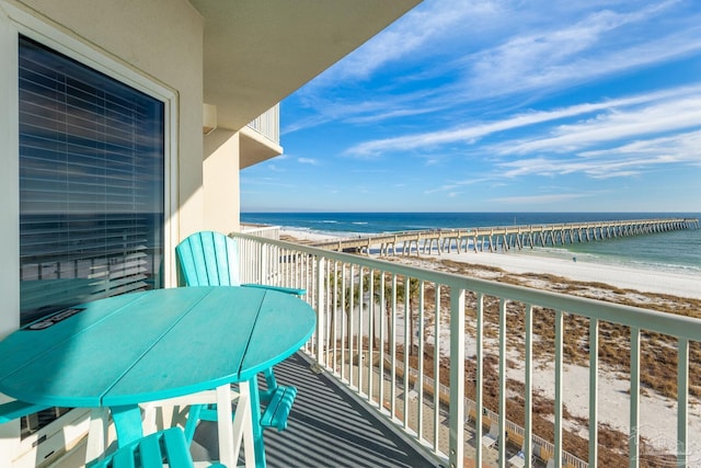 balcony with a water view and a beach view