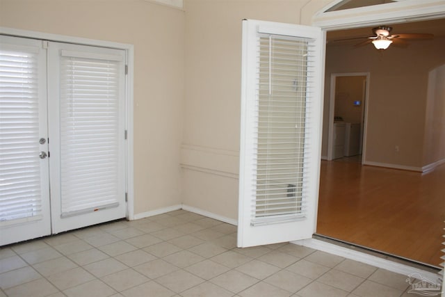 unfurnished room with washer / dryer, baseboards, a ceiling fan, and light tile patterned flooring