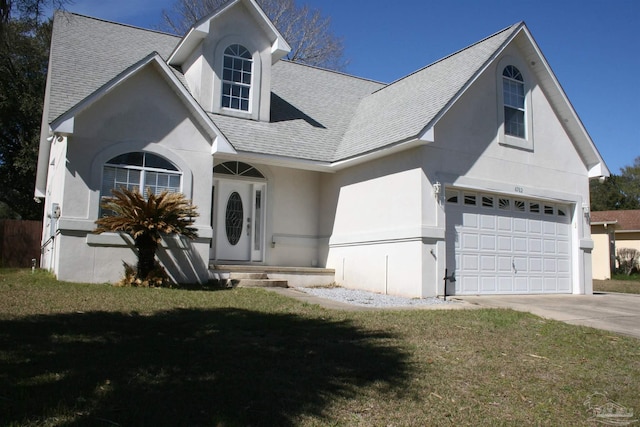 view of front of property featuring roof with shingles, stucco siding, a front yard, a garage, and driveway