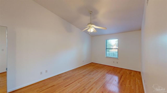 spare room featuring ceiling fan, lofted ceiling, and light hardwood / wood-style floors