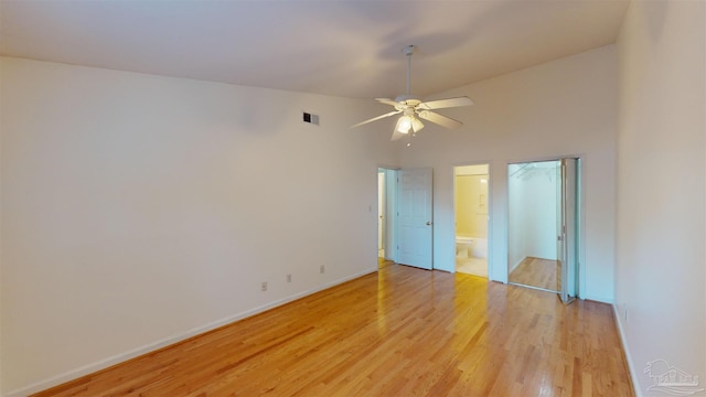 unfurnished room with ceiling fan, lofted ceiling, and light wood-type flooring