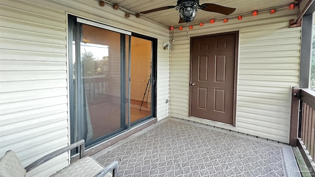 view of exterior entry featuring ceiling fan