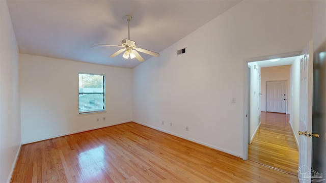 empty room featuring vaulted ceiling, ceiling fan, and light hardwood / wood-style floors