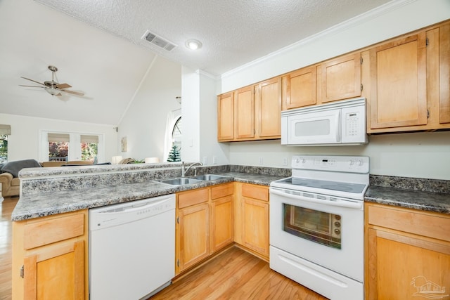 kitchen with a textured ceiling, white appliances, sink, light hardwood / wood-style floors, and lofted ceiling