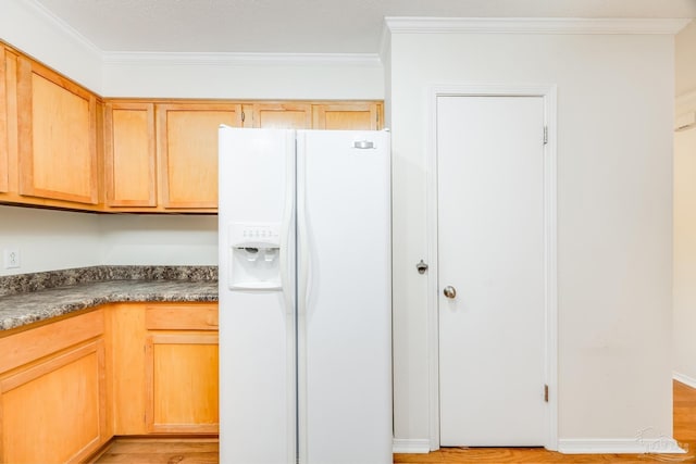 kitchen with white fridge with ice dispenser, ornamental molding, and light wood-type flooring