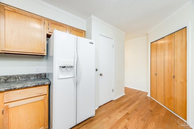 kitchen featuring light brown cabinetry, a textured ceiling, crown molding, white refrigerator with ice dispenser, and light hardwood / wood-style floors