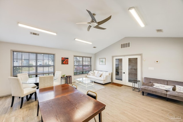 living room with ceiling fan, french doors, vaulted ceiling, and light hardwood / wood-style flooring