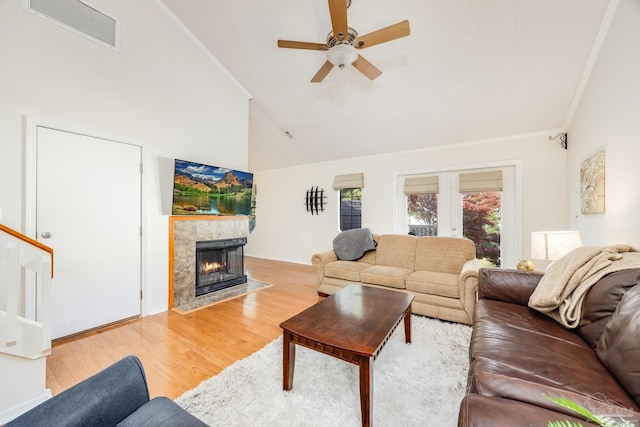 living room featuring ceiling fan, french doors, high vaulted ceiling, and light hardwood / wood-style floors