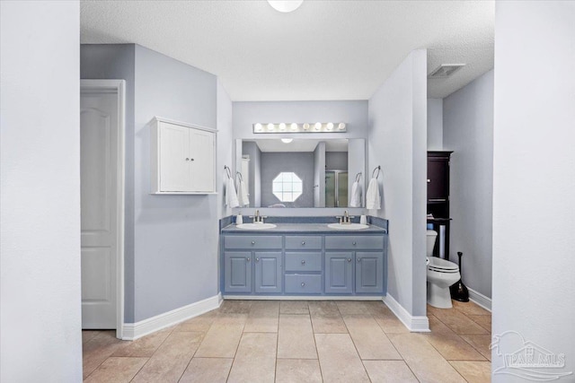 7951 Amethyst Dr, Pensacola, FL 32506 - full bathroom featuring toilet, double vanity, tile patterned flooring, and baseboards