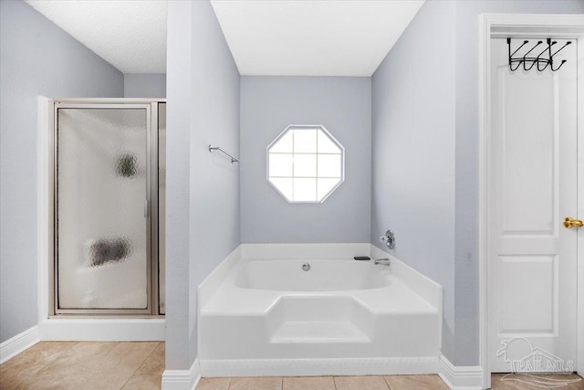 7951 Amethyst Dr, Pensacola, FL 32506 - full bath with a garden tub, a stall shower, tile patterned floors, and baseboards