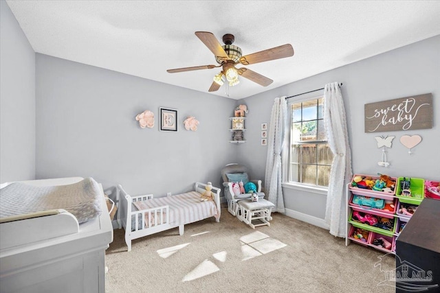 7951 Amethyst Dr, Pensacola, FL 32506 - bedroom featuring a crib, carpet floors, ceiling fan, and baseboards