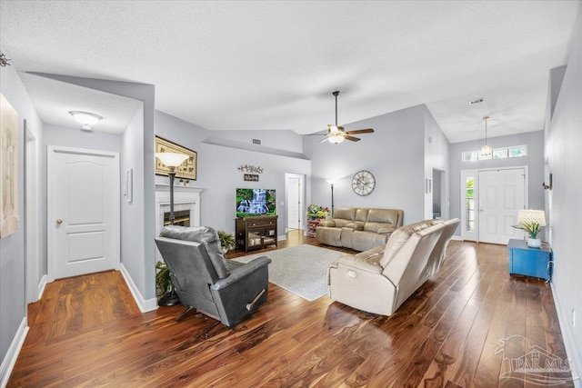 7951 Amethyst Dr, Pensacola, FL 32506 - living area featuring dark wood-style flooring, a fireplace, vaulted ceiling, baseboards, and ceiling fan