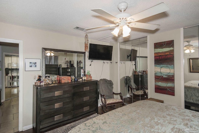 bedroom with ceiling fan and a textured ceiling