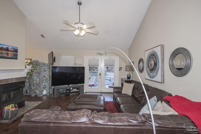 living room with hardwood / wood-style floors, high vaulted ceiling, french doors, and ceiling fan