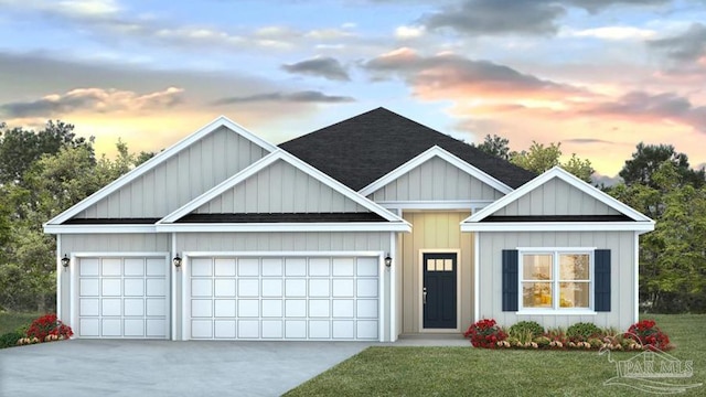 view of front of property with a garage and a yard