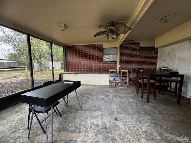 sunroom / solarium featuring ceiling fan