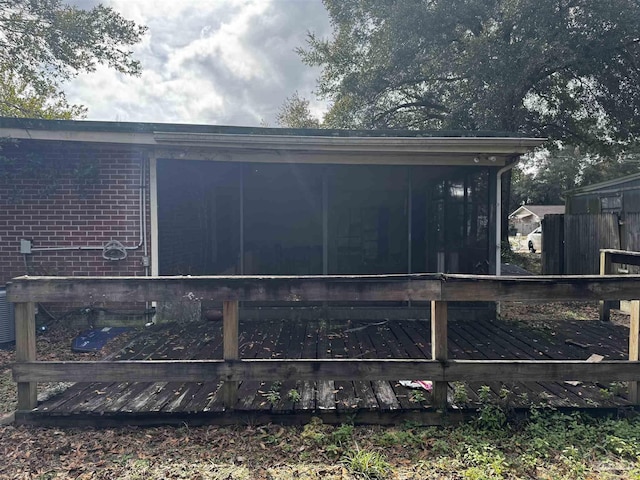 view of property exterior with a sunroom