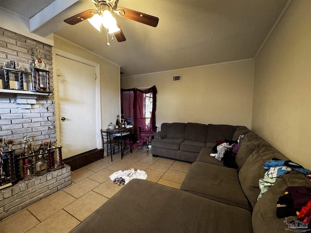 living room featuring light tile patterned floors, a textured ceiling, ornamental molding, and ceiling fan