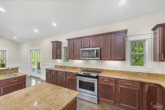 7515 Whiting Acres Ln, Milton, FL 32570 - kitchen with stainless steel appliances, light stone counters, vaulted ceiling, and recessed lighting