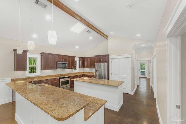 7515 Whiting Acres Ln, Milton, FL 32570 - kitchen featuring appliances with stainless steel finishes, beamed ceiling, a kitchen island with sink, light stone countertops, and plenty of natural light