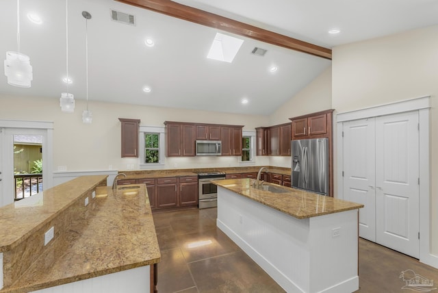 7515 Whiting Acres Ln, Milton, FL 32570 - kitchen with appliances with stainless steel finishes, beamed ceiling, a kitchen island with sink, light stone counters, and a skylight