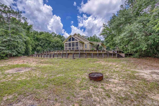 7515 Whiting Acres Ln, Milton, FL 32570 - view of grassy yard featuring an outdoor fire pit, a wooden deck, and stairs