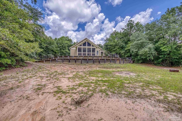7515 Whiting Acres Ln, Milton, FL 32570 - rear view of house with a wooden deck and a wooded view