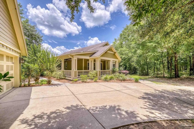 7515 Whiting Acres Ln, Milton, FL 32570 - rear view of house featuring covered porch and roof with shingles