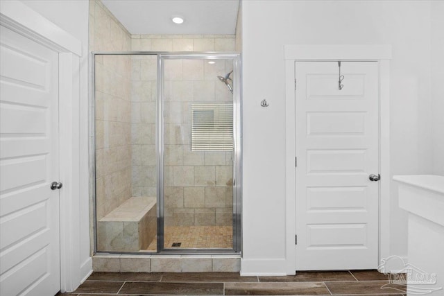 bathroom featuring a shower stall and wood tiled floor
